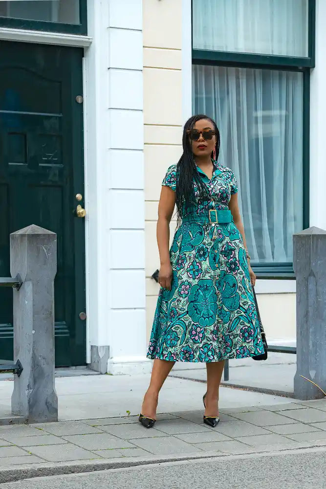 A Model wearing a Teal Midi African print belted dress for women's fashion by Heritage Clothings.