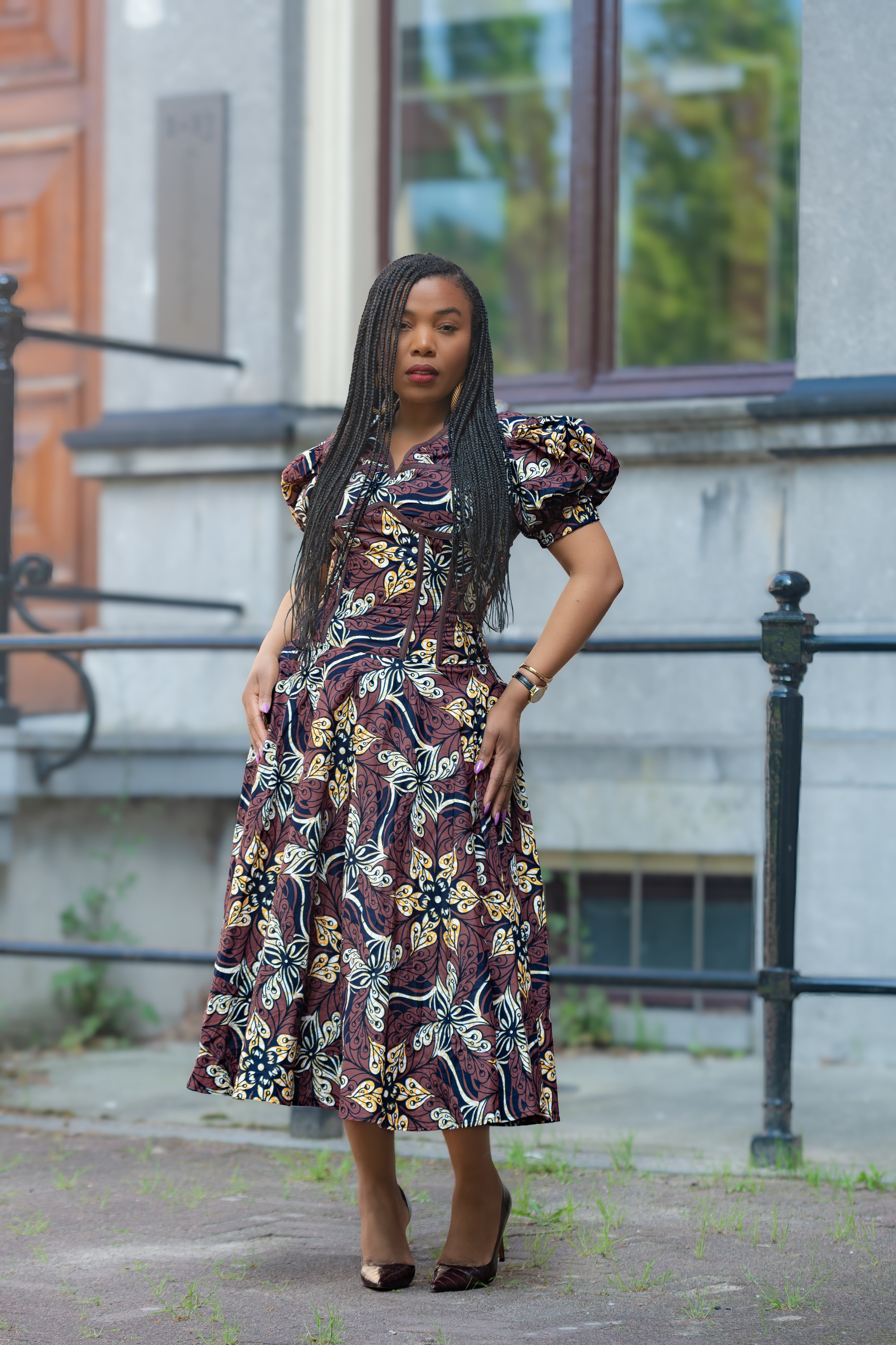 Model wearing Amara Mocha African Ankara print Midi dress by Heritage Clothings
