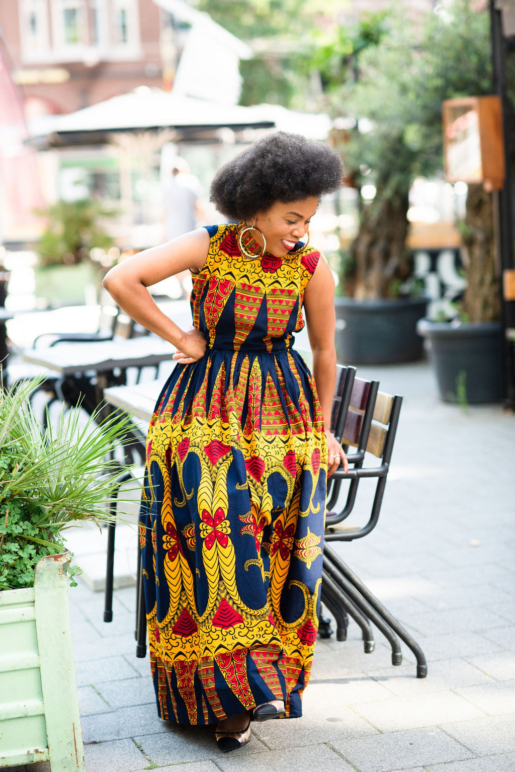 Model wearing an African print sleeveless Ankara Maxi dress in Navy blue & Orange