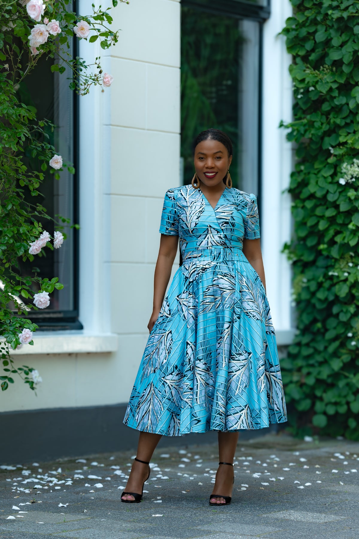 Font view Detail of Aqua and Ivory Gold African print Midi Dress with V neckline & matching Belt.