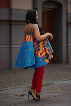 Side view detail on African print multicolor Top paired with heels