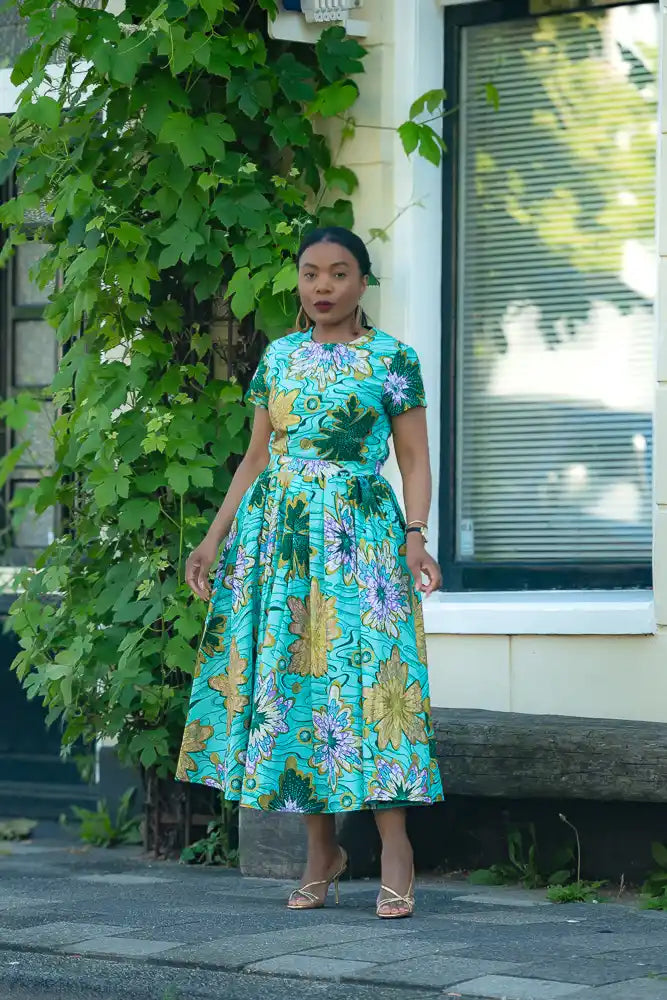 A model wearing a 100% Cotton African floral print Women's fashion outfit in MINT green by Heritage Clothings