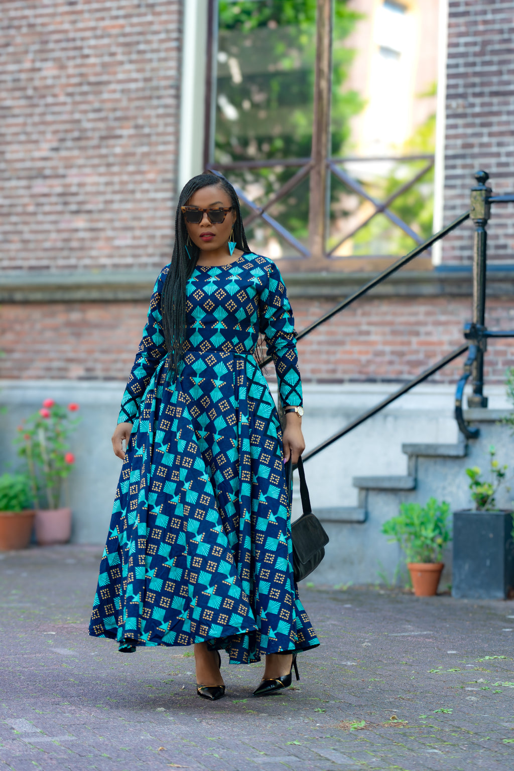 Model wearing the Moyo Blue and brown African print Ankara Maxi dress by Heritage Clothings