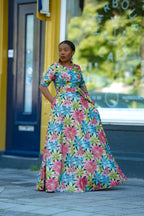 Model wearing a Floral Gold African print Maxi Cotton Dress with Fitted Silhouette.