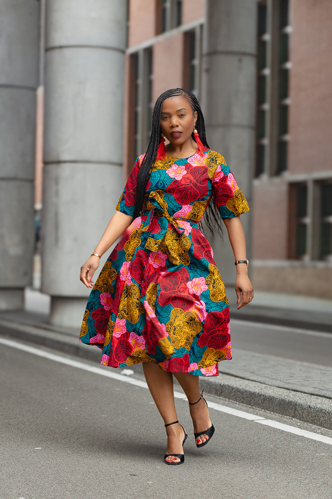 Model wearing a floral African print Midi Dress by Heritage Clothings