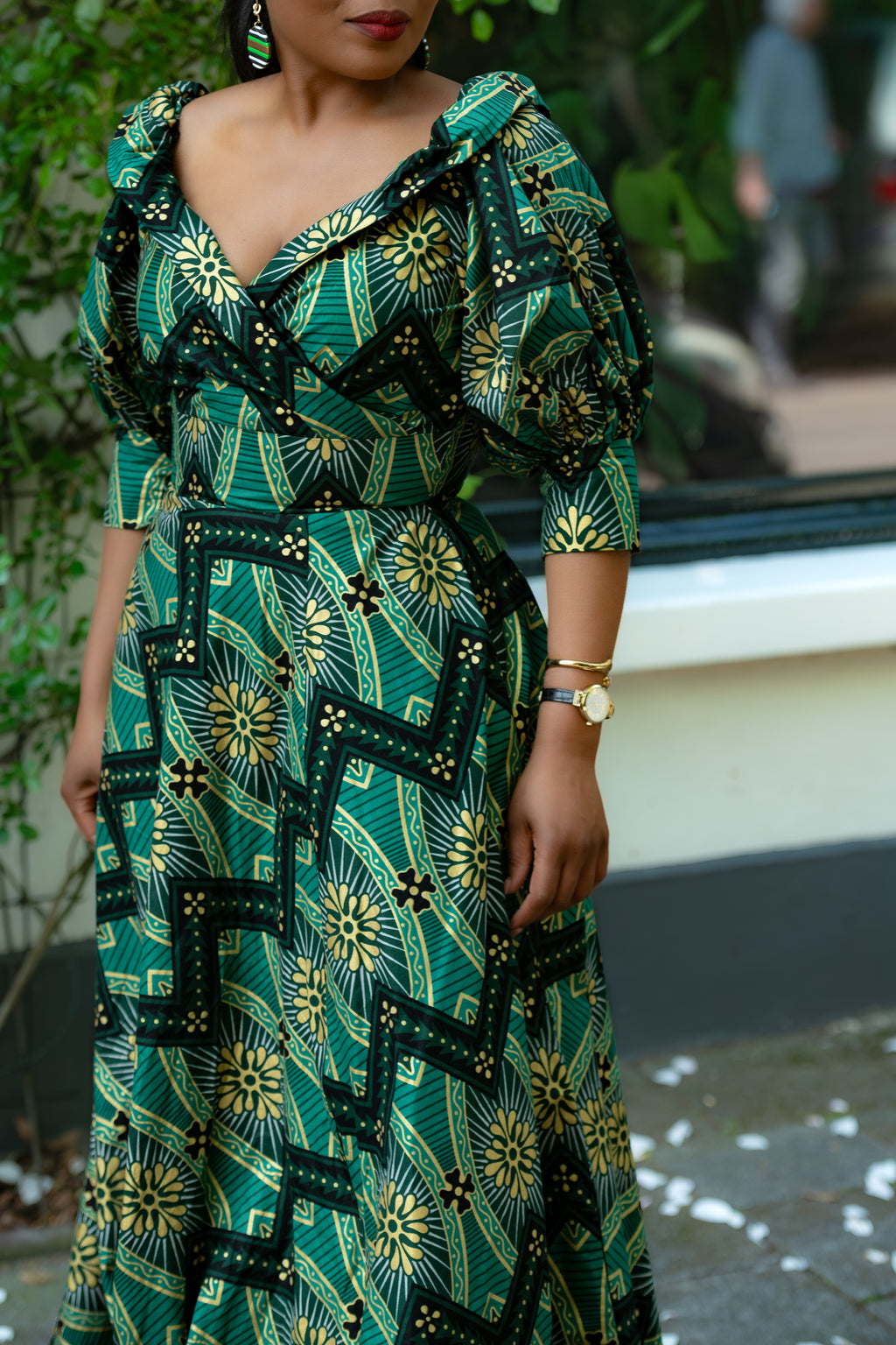 Close up of Green and Gold African print Ankara Maxi Dress with fitted waist and  puff sleeves.