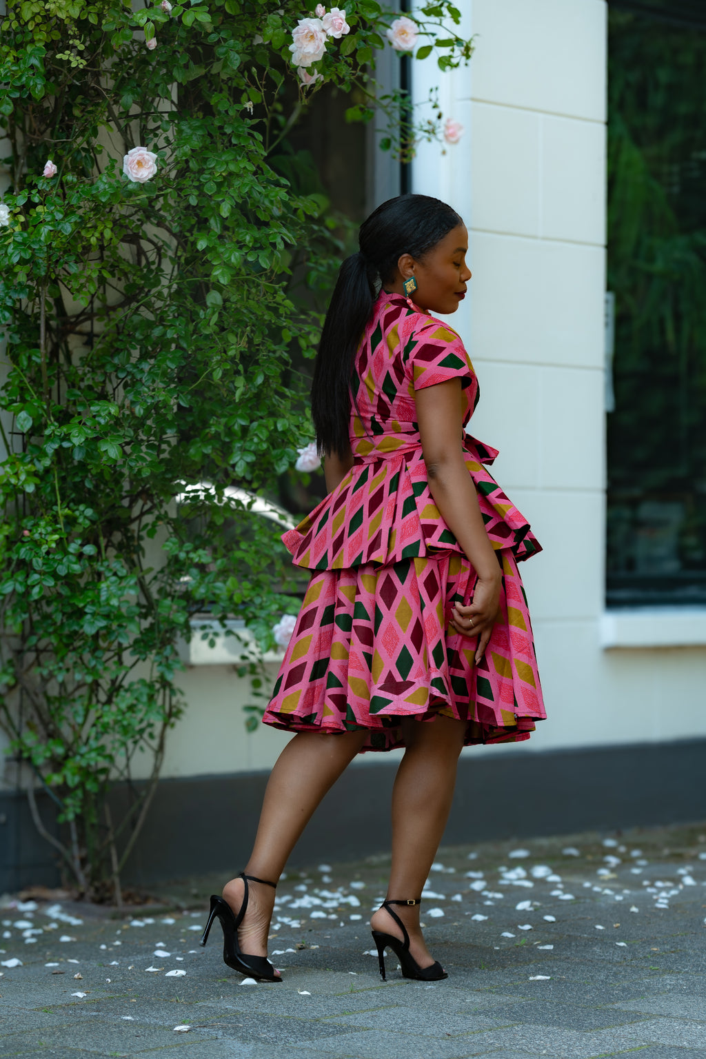 Side detail of Pink African print Cotton Peplum Top with Front Zipper, waist Tie and matching Skirt.