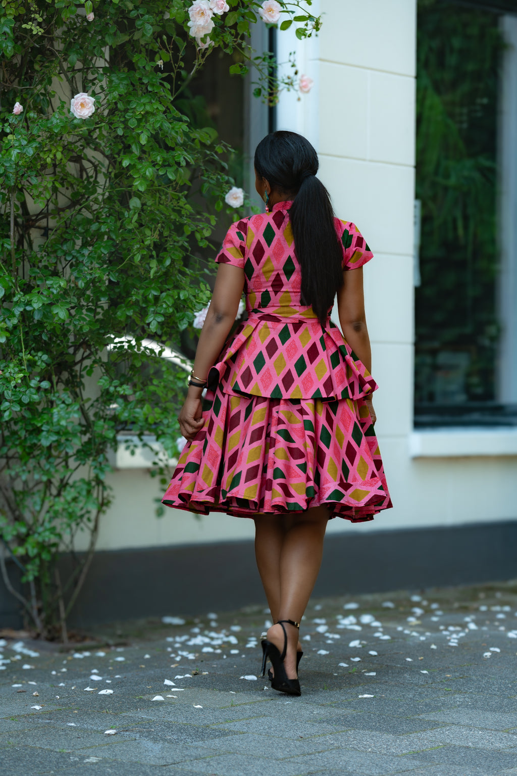 Back detail of Pink African print Cotton Peplum Top with Front Zipper, waist Tie and matching Skirt.