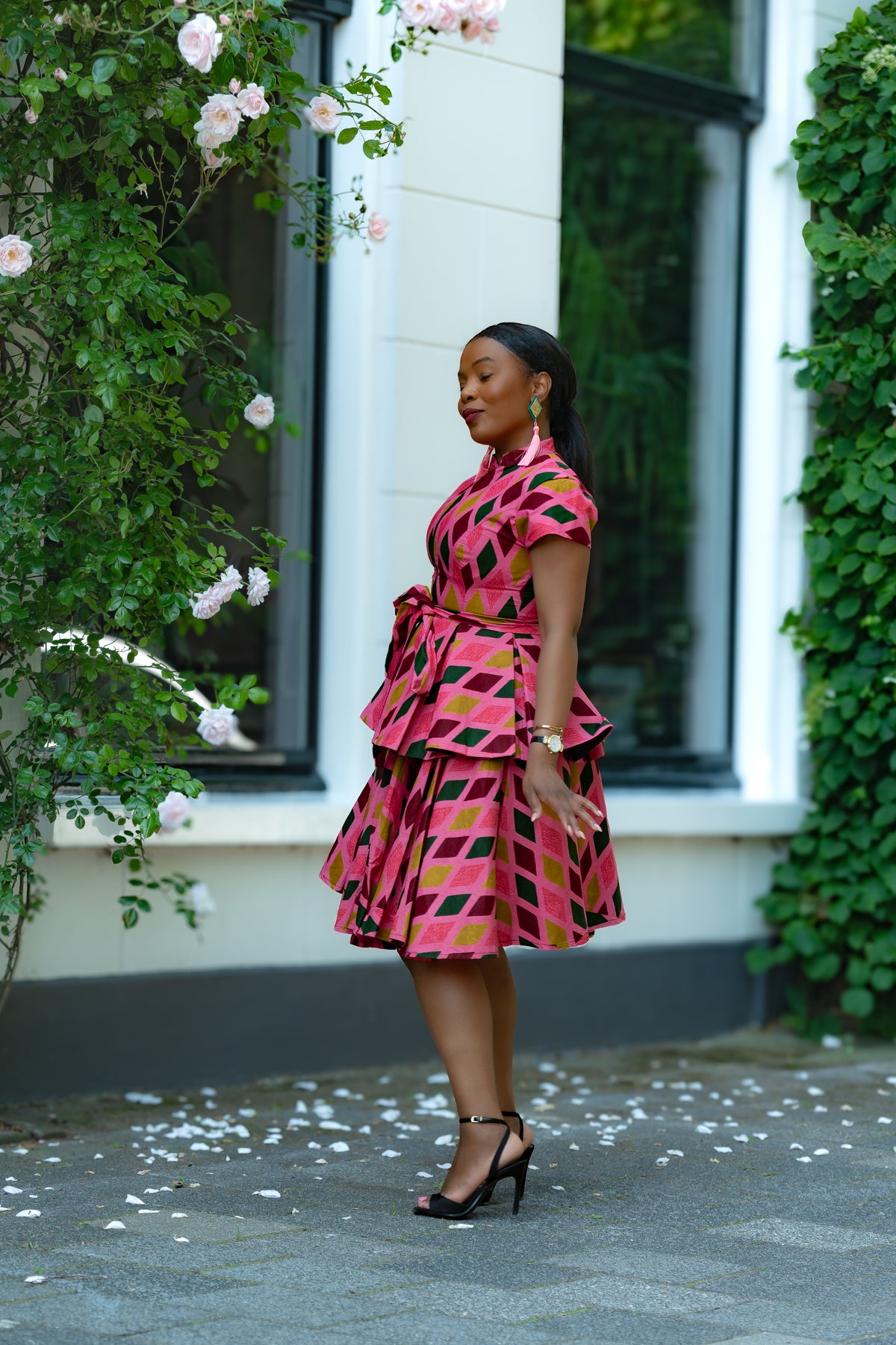 Side detail of Pink African print Cotton Peplum Top with Front Zipper, waist Tie and matching Skirt.