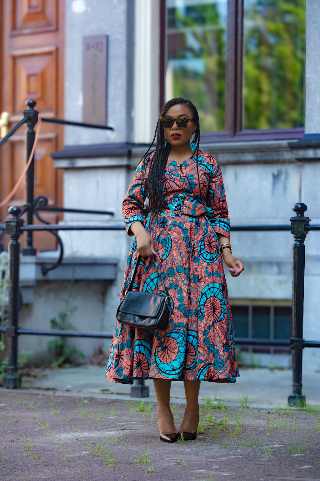 Model wearing a yaya coral African print Ankara Midi dress by Heritage clothings