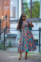 Floral African print Ankara maxi dress styled with a black bag 