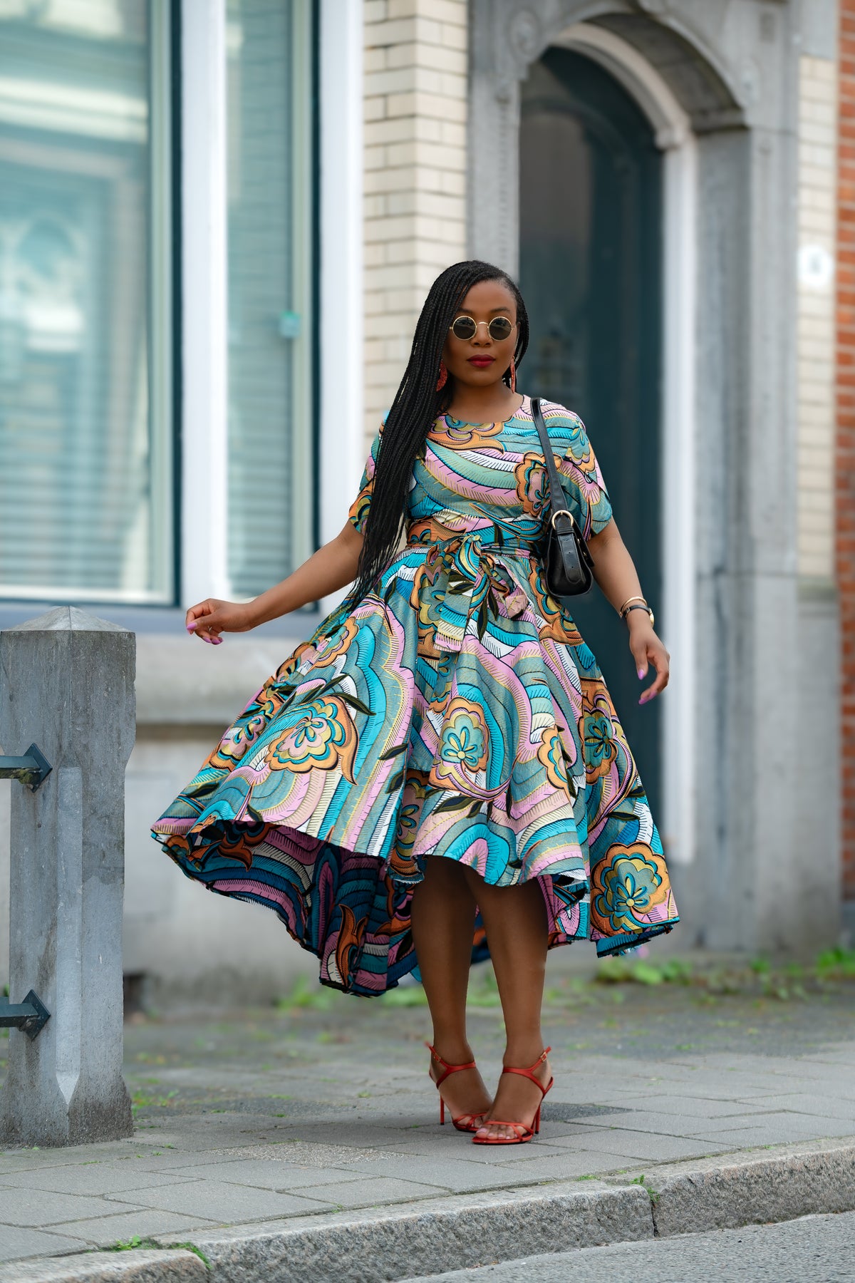 Front view detail of Model wearing Zenaida Multicolour African print Cotton Midi Dress with matching Belt.